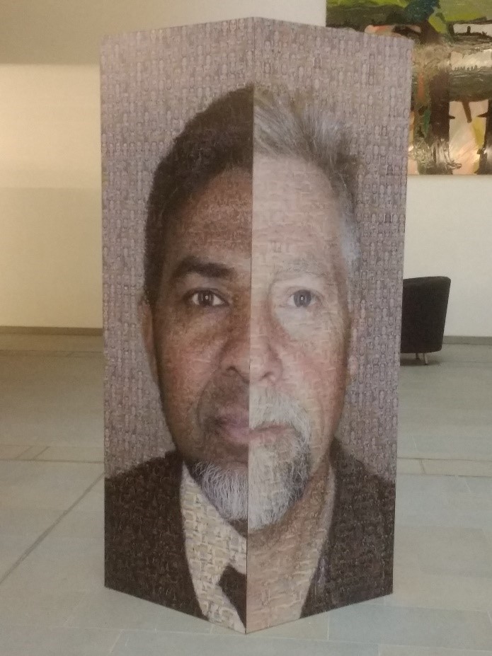Colour image of a large artwork. Two half faces are depicted, these have been put together to create a single face. Each face is comprised of lots of smaller tiled images.