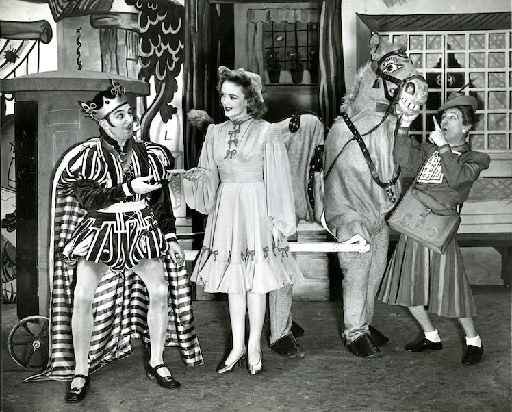 A black and white photograph of a traditional scene from a panto with pantomime horse!